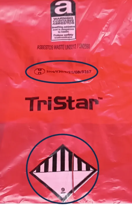 Red asbestos waste bag with "TriStar" logo, hazard symbol with stripes, and text warnings on handling asbestos.